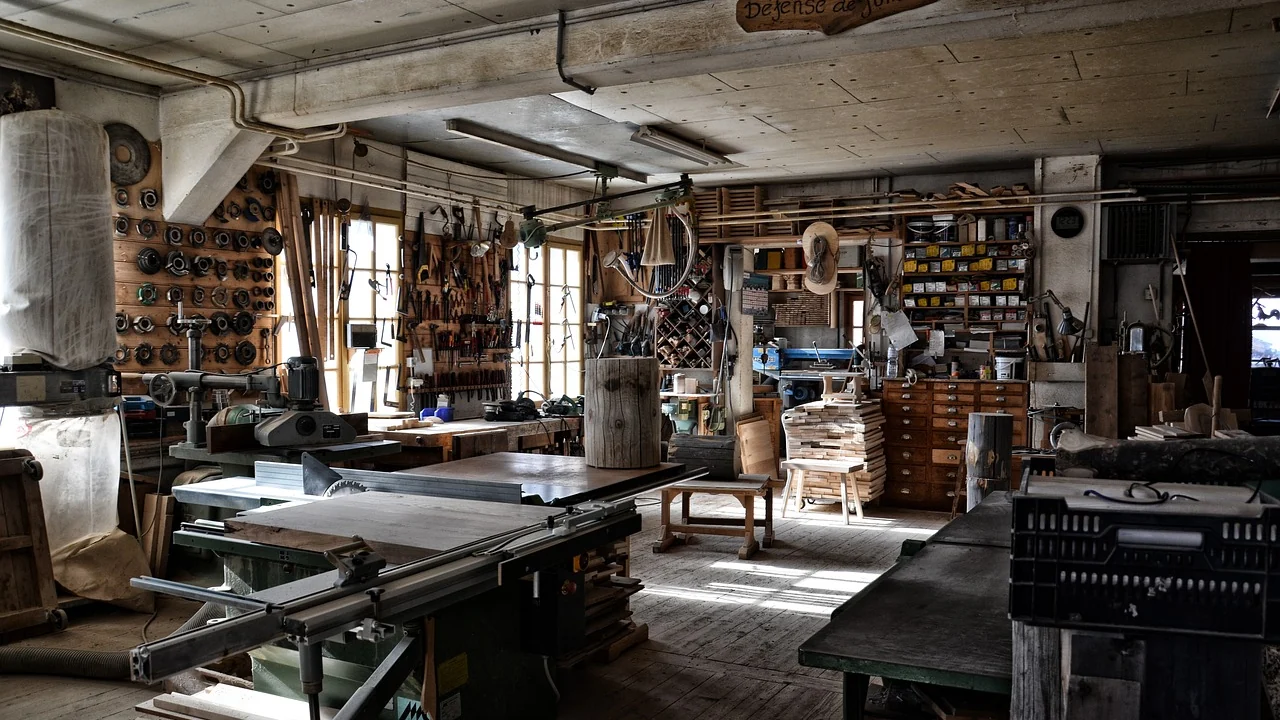 A joiner's workshop, benches and machinery under daylight from the windows