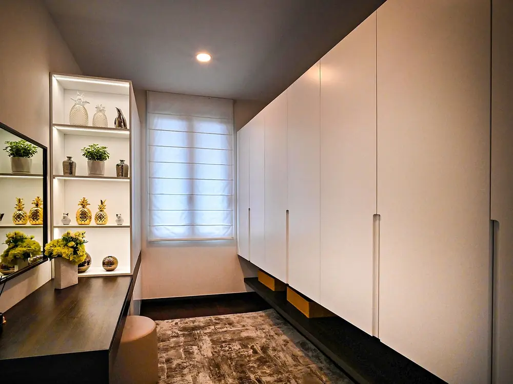 Floor-to-ceiling fitted units running the length of a narrow hallway